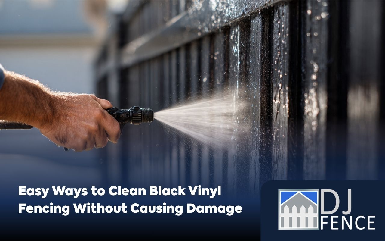 Homeowner washing a black vinyl fence with simple cleaning tools